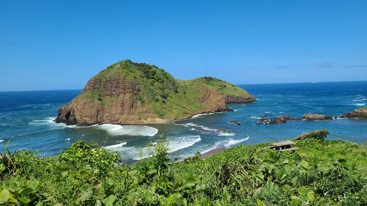 Sado Island coastline with green hills and blue water