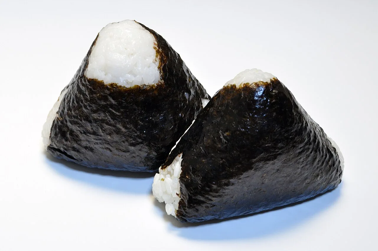 Two nori-wrapped onigiri rice balls; a generic food reference, not a meal from Yukinto.