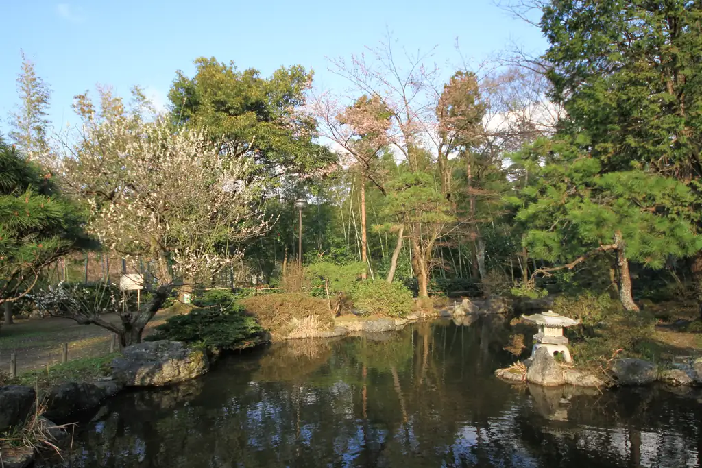 A pond, stone lantern and garden planting in Akiha Park.