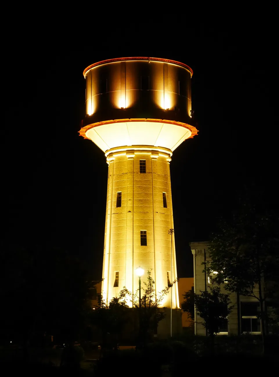 Nagaoka’s historic water tower glowing gold against the night sky