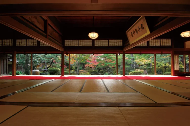 A tatami hall with wooden beams opens onto a garden at the Northern Culture Museum in Soumi, Niigata.