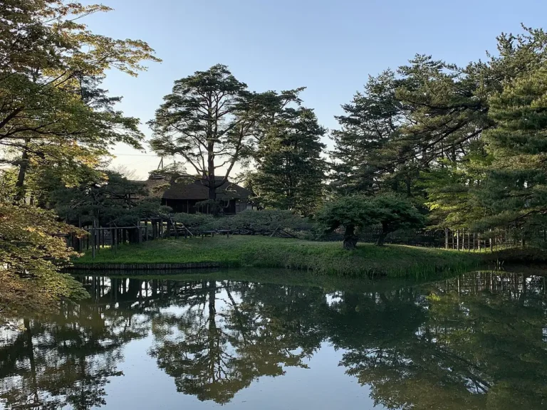 Pond, pine trees and teahouse at Ijimino Ochaya Garden